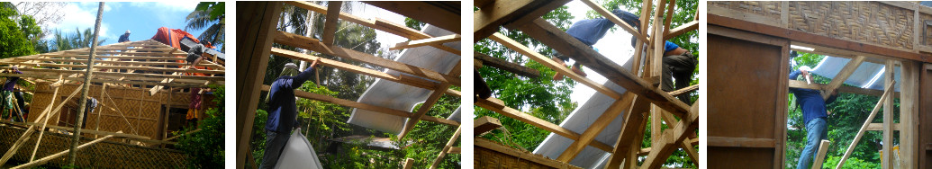 Imags of workmen changing roof of tropical house