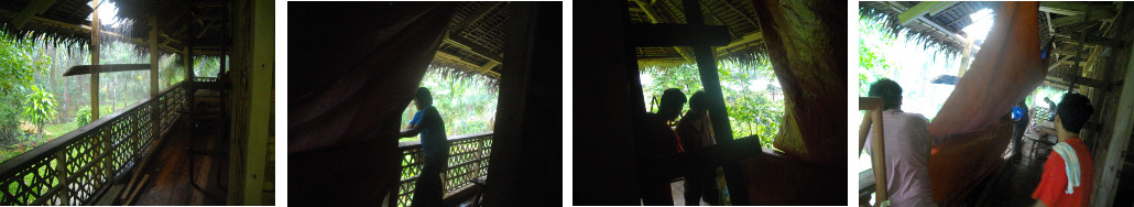 Images of Workmen putting up tarpaulin against rain whle
        changing the roof of a tropical house